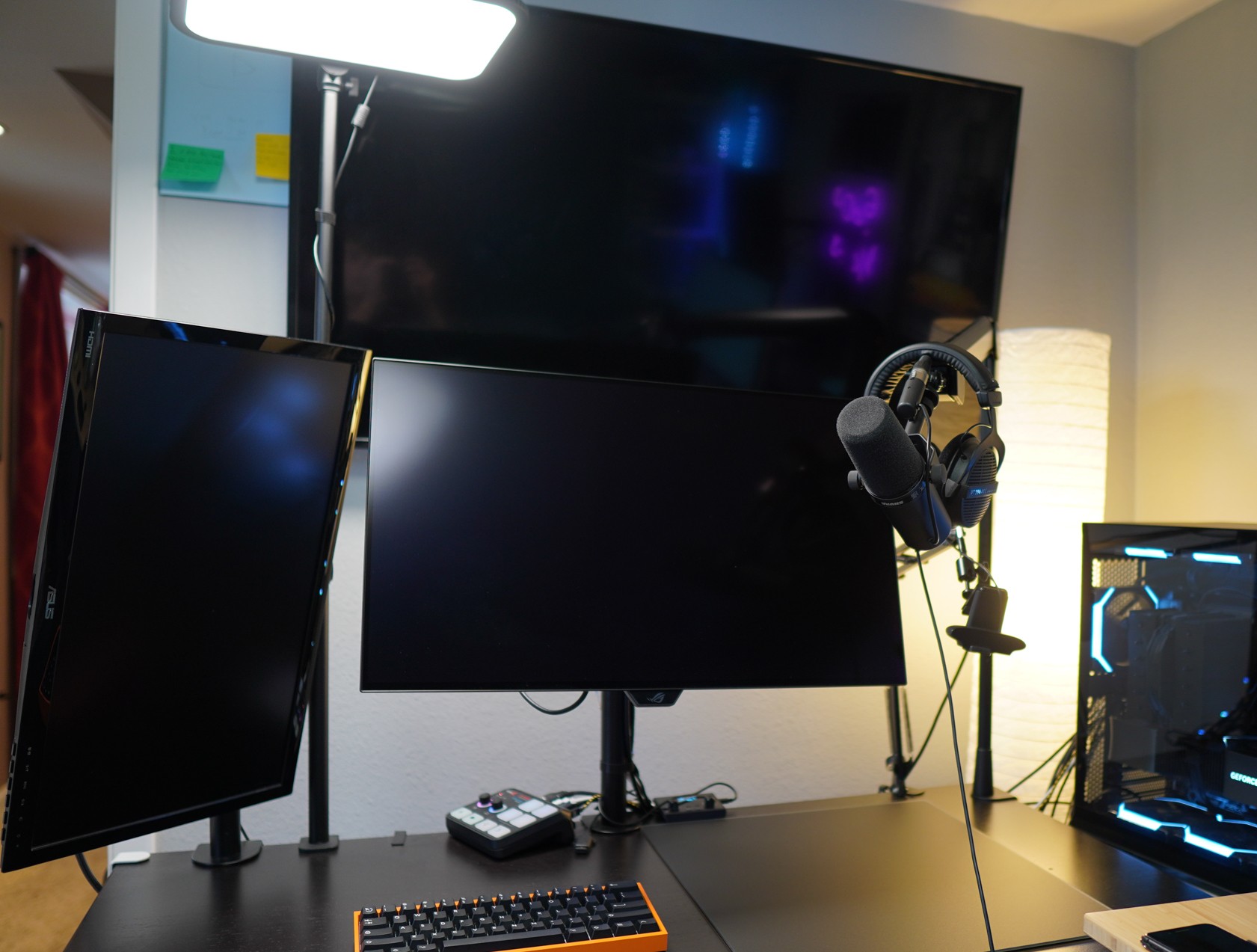 Gaming setup with 2 monitors tv wooting keyboard pc in background